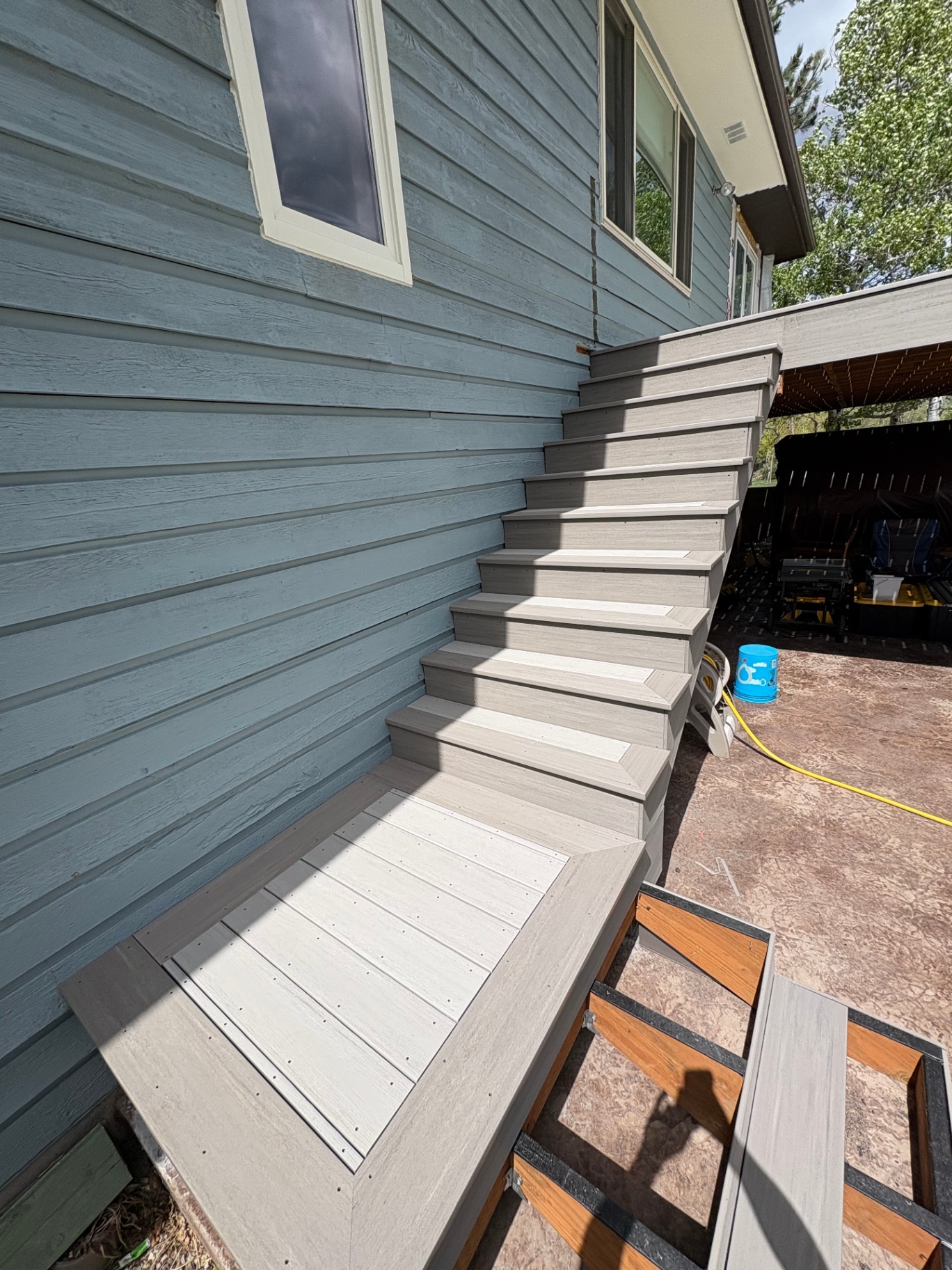 Composite stairs down blue siding