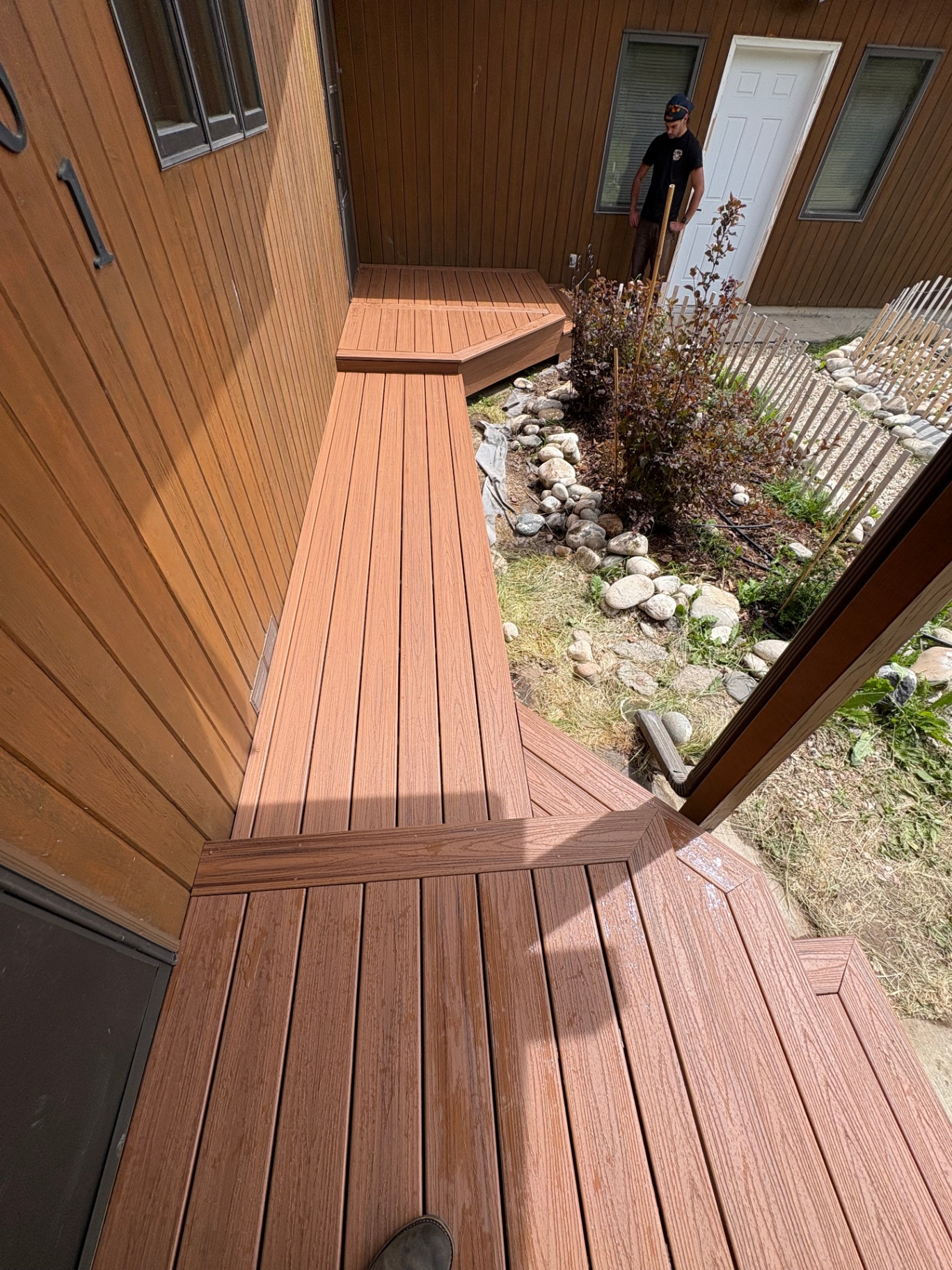Wrap-around composite deck along home exterior