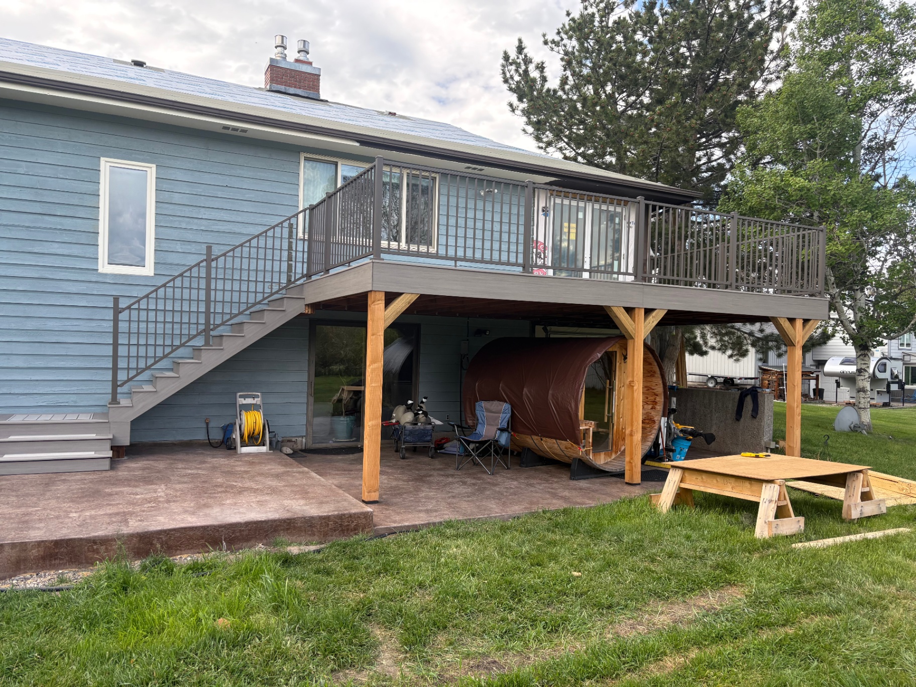 Full elevated deck with stairs and covered patio
