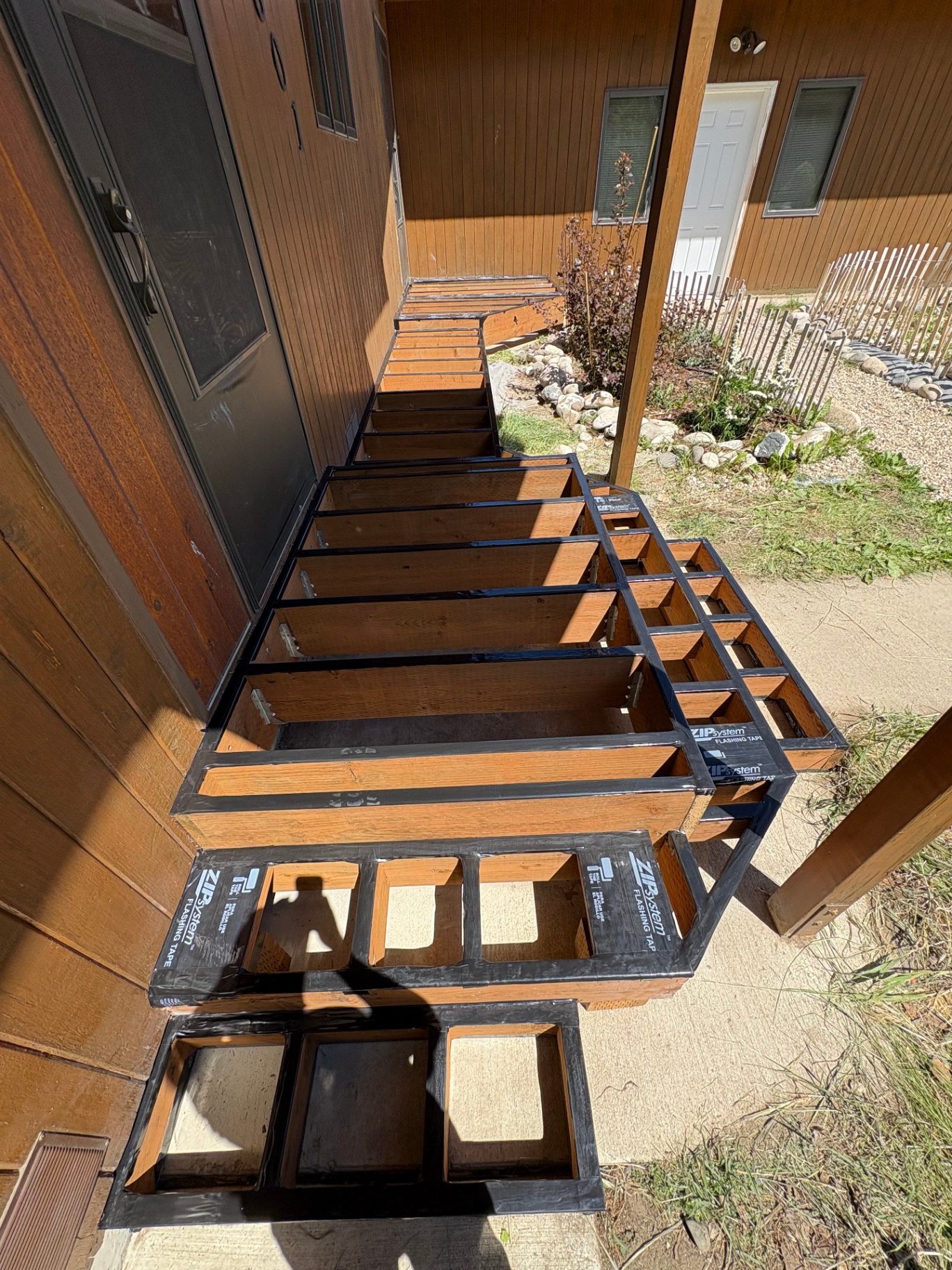 Waterproof flashing tape on deck framing and stair stringers